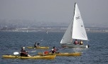 Kayaks beside sailboat  in Crown Cove