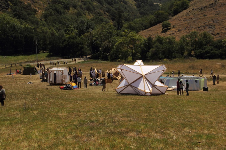 Team Uhrwerk (l) and team Helios’ structures sit at the base of a Poly Canyon hill near the end of a nearly mile-long pathway competitors carried building materials up the day before.