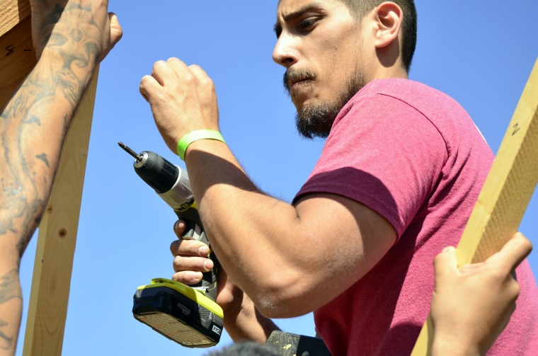 Luis Montoya drills screws into Team Helios’ structure.