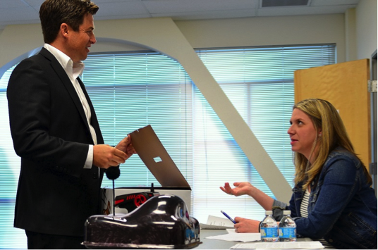 William Bowen shows off the “Go-Go Dog Pal” to an ABC producer before test driving it around the conference room
