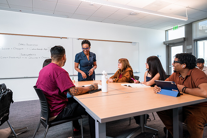 Dr. Shaunte Griffith-Jackson assisting students in the classroom.