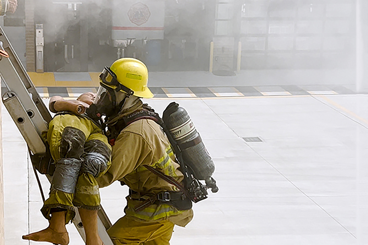 Fire Science student participating in a fire rescue simulation.