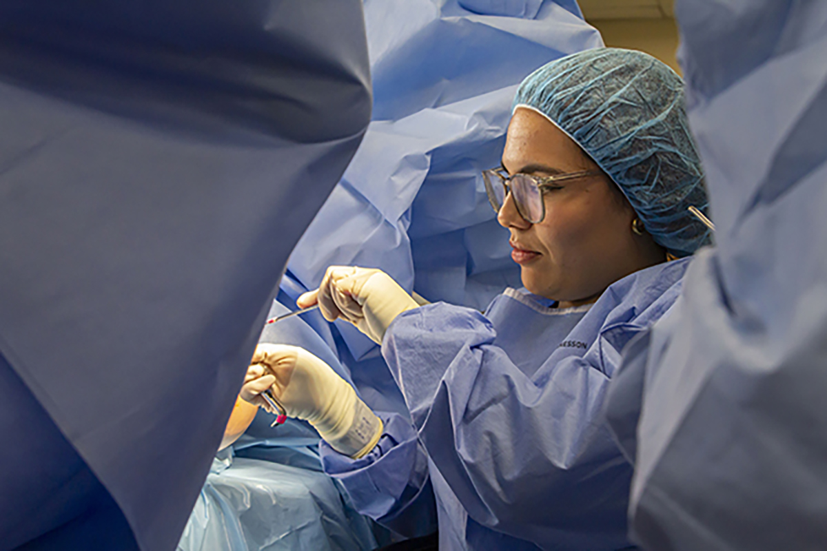 Surgical Technology student practicing her career skills in the lab.