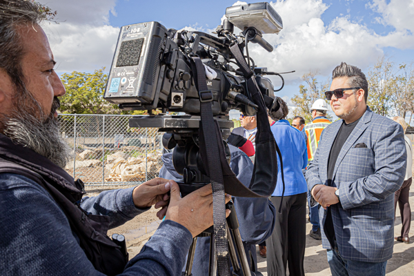 Reporter interving Board President Roberto Alcantar