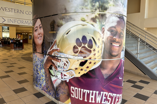 Branded building column with students faces 