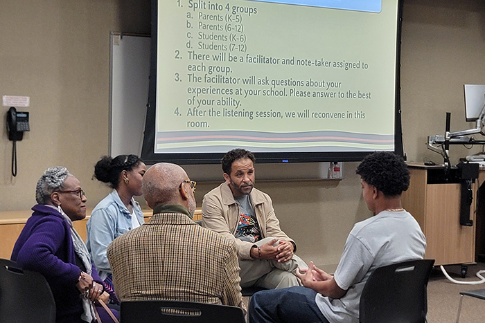 The Black Education Community Collective (BECC) speaking with a student. The Black Education Community Collective (BECC) speaking with a student.