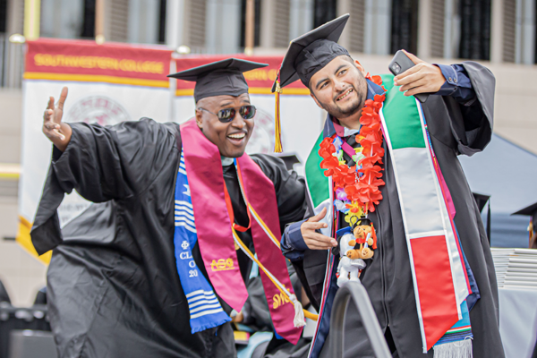 SWC Student and staff member taking picture while celebrating graduation ceremony