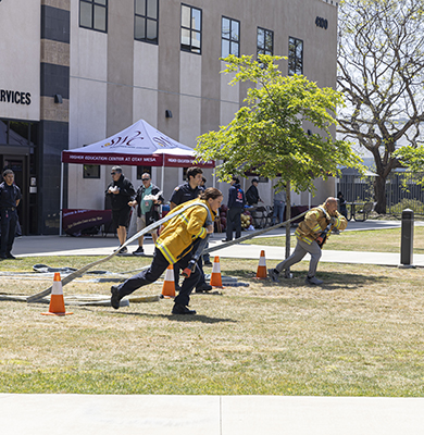 Southwestern College Fire Science students running a speed hose drill.