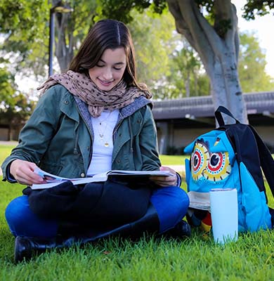 Female student reading a textbook