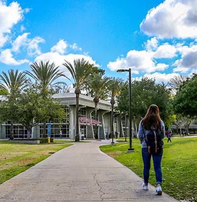 Female student walking on campus.