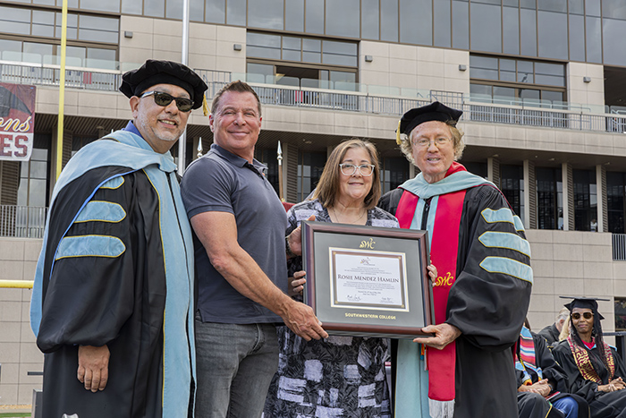 2026 Honorary Degree Recipient, Rosie Mendez Hamlin's children (middle), posing with Dr. Mark Sanchez (left) and Dr. Max Branscomb (right).