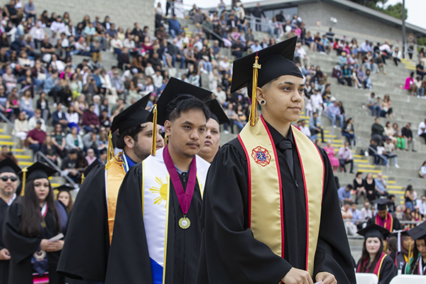 Students getting ready to walk on stage at Commencement 2023-24.