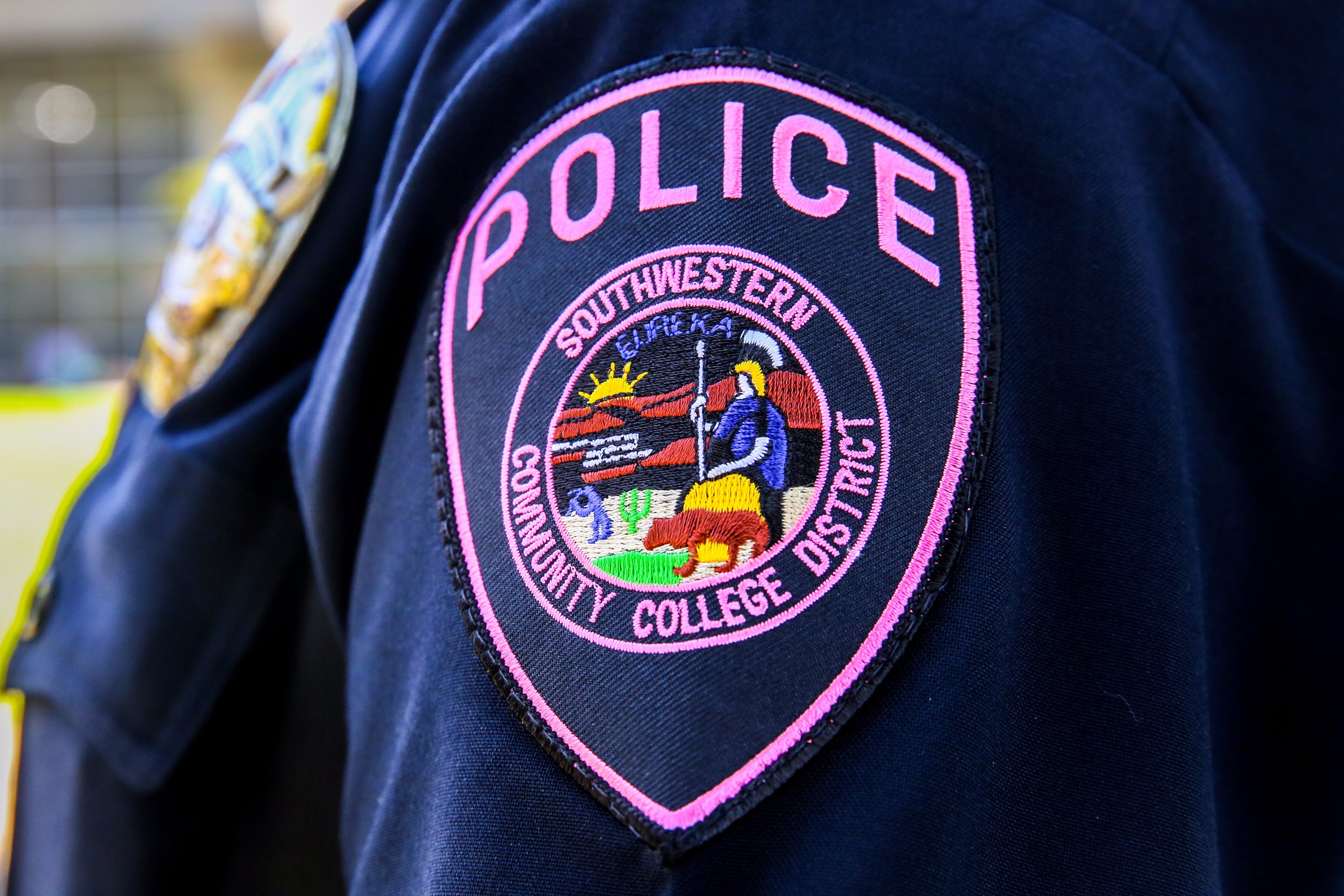 Close-up of pink SWCPD badge for Breast Cancer Awareness Month