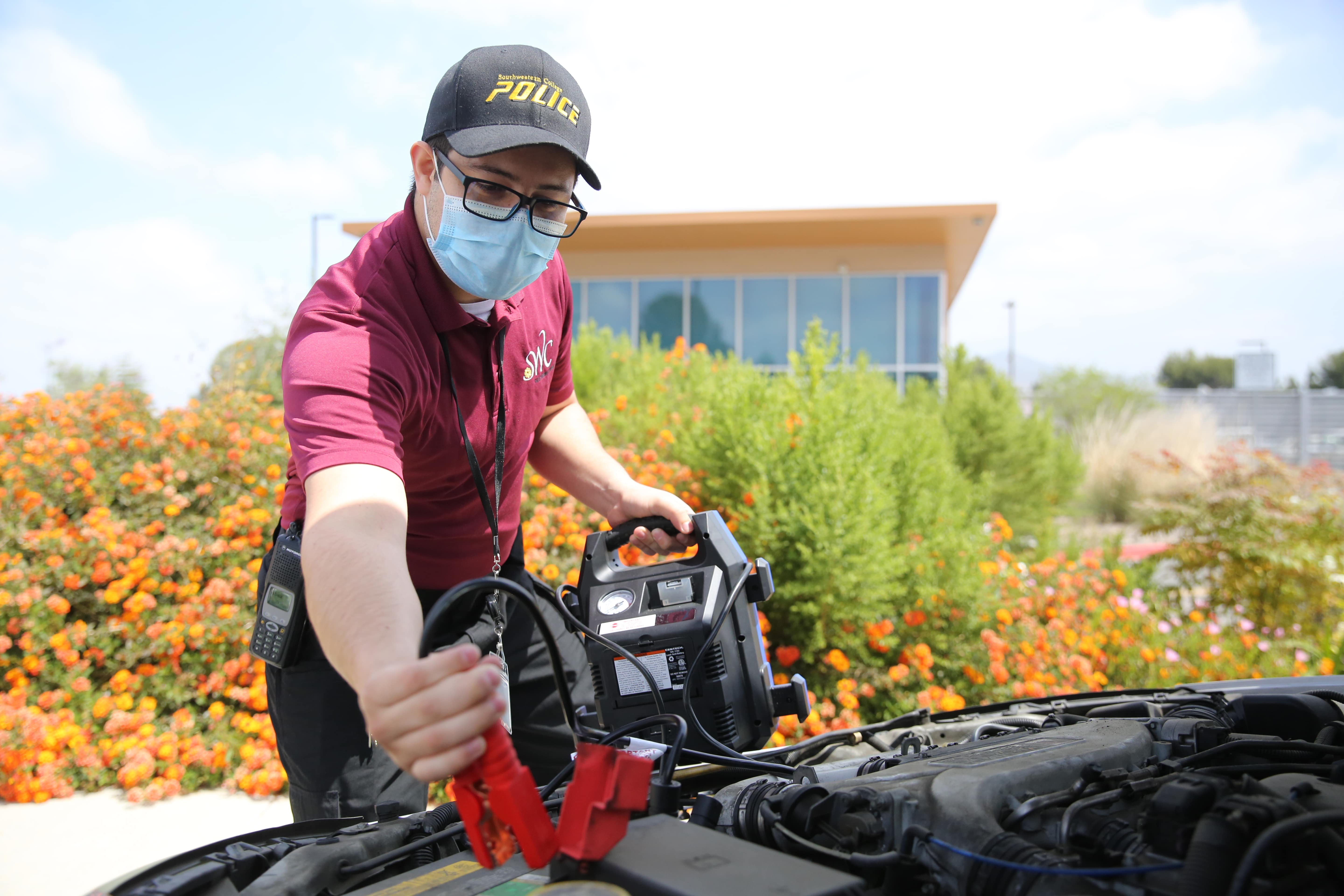 A CSO jump starting a vehicle 