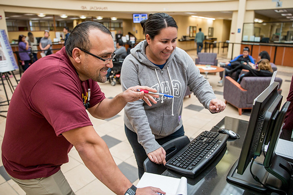 2 persons working on a computer