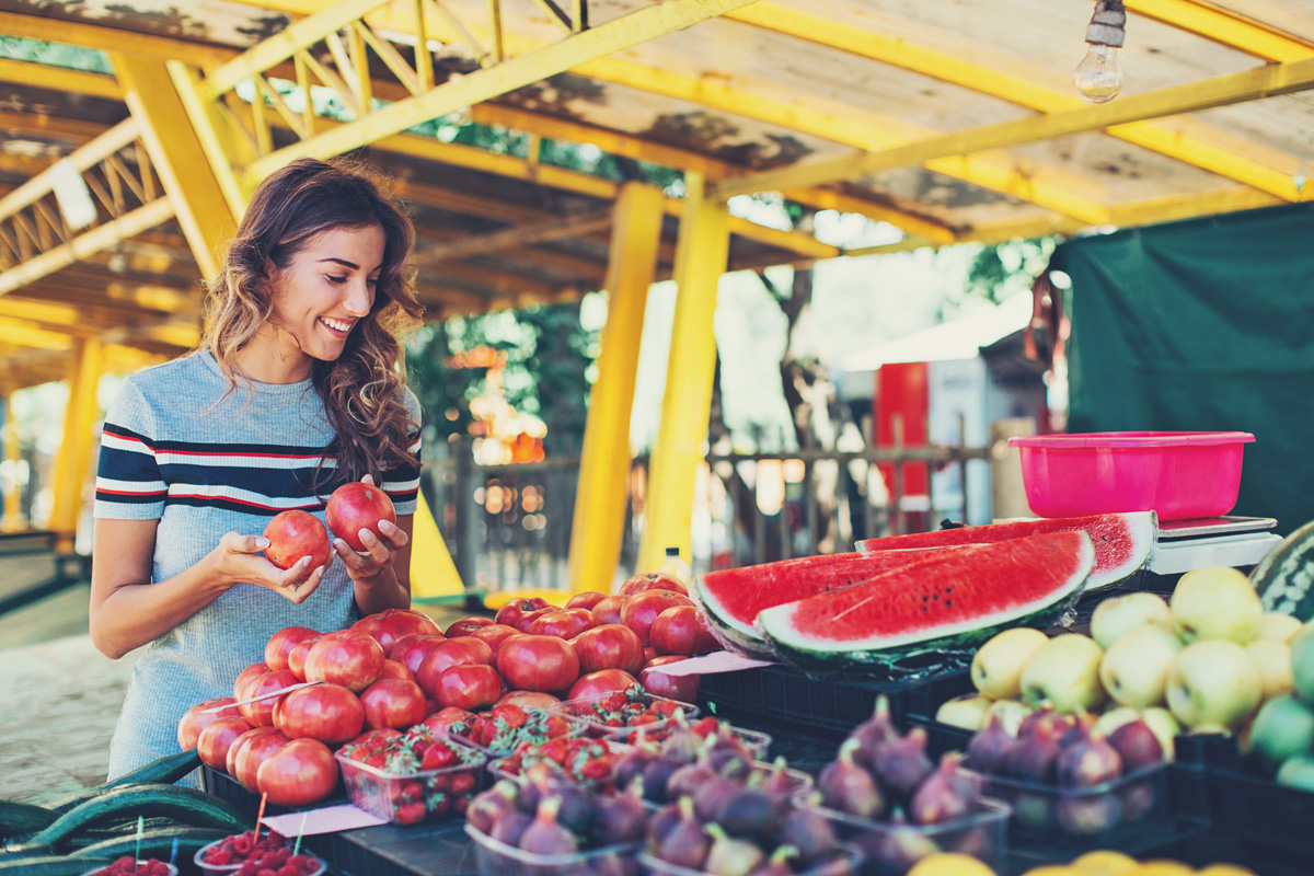 Photo of a female student browsing fruits and vegetables.