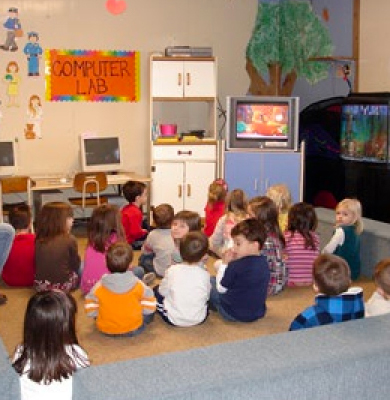 Children at daycare in front of a TV