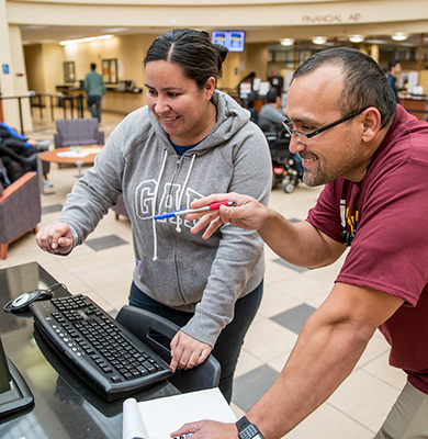 Image of people looking at computer