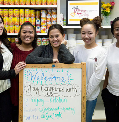 Image of peope with welcome sign