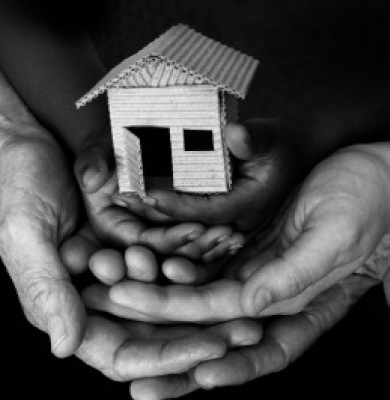 Hands holding a model house