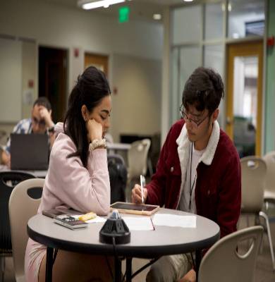 Two students working together on computers