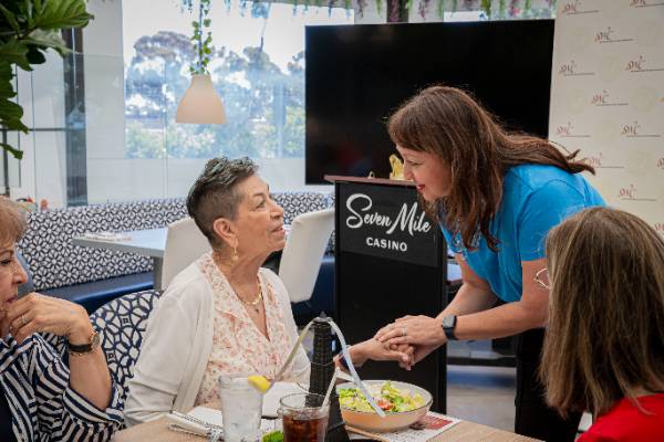 Sofia Salgado Robitaille, Executive Director, speaking with a Golden Jaguar SWC retiree Sofia Salgado Robitaille, Executive Director, speaking with a Golden Jaguar SWC retiree.